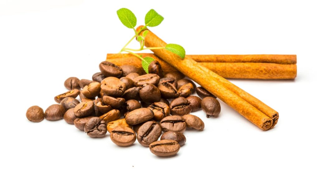 coffee beans and cinnamon sticks - Coffee Paradiso